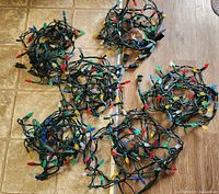 Six bundled strings of multi-colour LED lights on floor