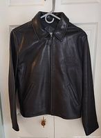 Front view of Port Authority black leather jacket showing zip front, collar, pockets