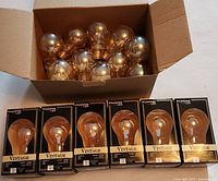 Open carton with 18 loose amber bulbs and 6 boxed bulbs