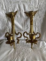 Front view of both brass sconces showing design and finish