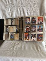 Binder open showing nine-pocket pages filled with Upper Deck baseball cards