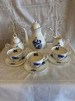 Full coffee set layout showing all nine porcelain pieces