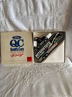 Box lid and die-cast truck displayed inside