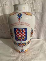 Front view of Heinrich porcelain vase showing coat of arms and floral decoration