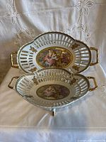 Two stacked porcelain platters showing top design and handles