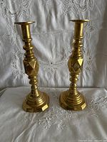 Front view of both brass candle holders