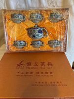 Boxed porcelain tea set showing all pieces