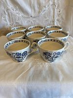 Group view of all eight porcelain tea cups