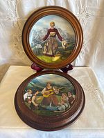 Both plates in their wooden frames, one standing, one lying flat