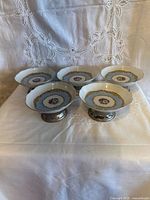 Five matching porcelain dessert dishes front view