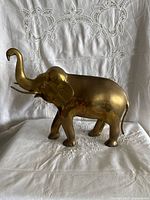 Left side view of brass elephant figurine