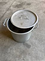 Stock pot with lid partially covering opening