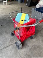 Beach cart with bodyboard and umbrella inside, showing overall lot