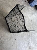 Screen set partly folded showing scrollwork and mesh