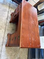 Full view of wood desk showing six drawers and overall form