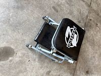 Creeper folded into seat form showing logo and frame