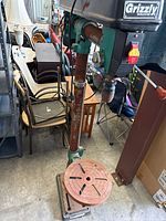 Full view of drill press showing column, table, base and brand label