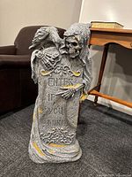 Front view of Grim Reaper tombstone showing inscription, raven, overall design