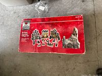 Box of Home Accents Holiday 20-Piece Porcelain Village Set with wear visible