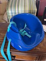 Overall view of blue booster seat showing form and color