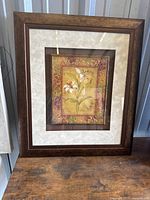 Front view of framed floral art showing full frame and matting