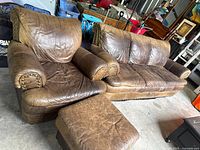 Sofa, armchair and ottoman showing overall design, leather color and wear