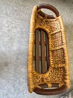 Top view of oval woven basket showing slatted wood base and handles