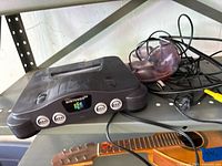 Front and top view of Nintendo 64 console with cables visible