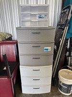 Stacked gray and white weave towers with clear 5-drawer organizer on top
