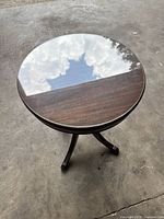 Top view of round mahogany-brown pedestal table
