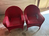 Front view of both red wicker armchairs