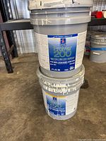 Stacked view of both Sherwin-Williams 5-gallon paint pails showing ProMar 200 labels