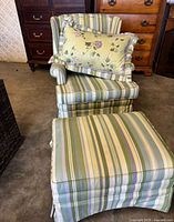 Armchair with ottoman and pillow front view