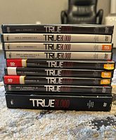 Stack of True Blood DVD cases showing disc numbers and spines