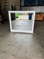Front view of square white framed mirror