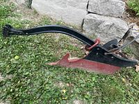 Full view of steel walking plow laying on grass
