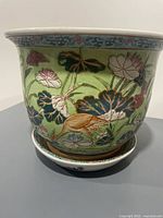 Overall view of porcelain planter on tray showing motif