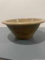 Side profile of large tan stoneware bowl