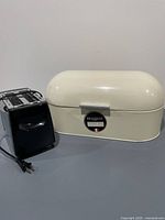 Bread bin closed beside toaster