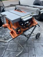 Overall view of Ridgid table saw mounted on folding rolling stand