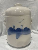 Front view of porcelain tea caddy showing landscape motif