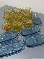 Group showing all amber sherbet dishes and blue relish trays