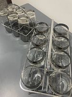 Both sets of glasses with respective metal carriers