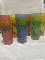 Six frosted tiki palm tree glasses grouped