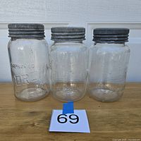 Front view of three jars with lids