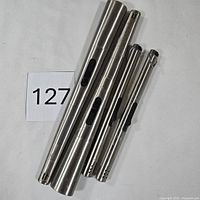 Four metal butane lighters laid out for full view and count