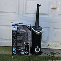 Humidifier beside original box, full view of both items