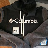 Front view of two-tone Columbia hoodie showing logo, drawstrings, size tag #206 visible