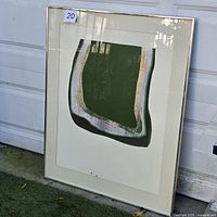 Full view of framed silkscreen print leaning against wall