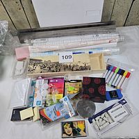 Overall view of entire lot showing wall slot, adhesive rolls, markers, sticky notes, desk accessories